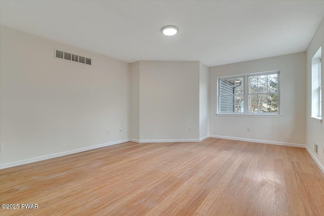 spare room featuring light hardwood / wood-style floors