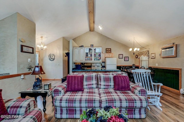 living area featuring light wood-type flooring, a wall unit AC, lofted ceiling with beams, and an inviting chandelier