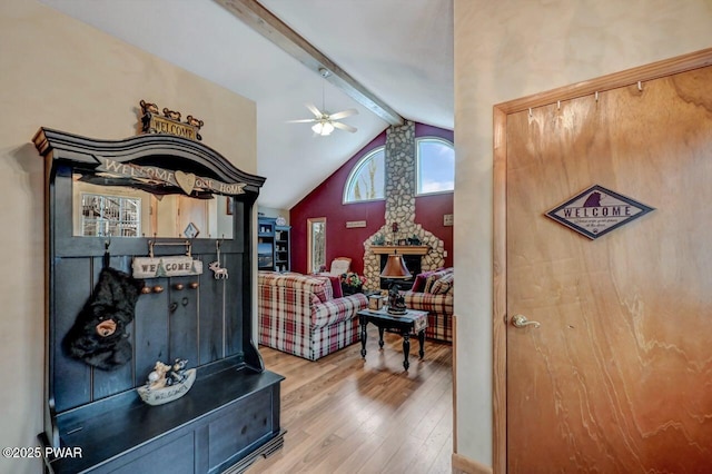 interior space with vaulted ceiling with beams and wood finished floors