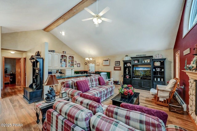 living area with light wood-style floors, beam ceiling, a fireplace, and high vaulted ceiling