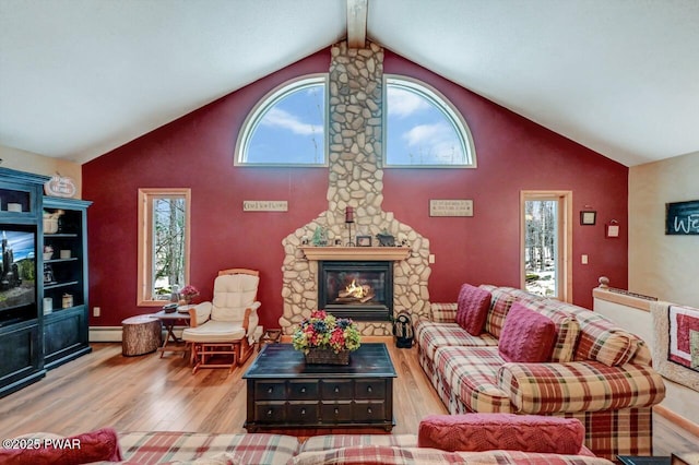 living area with high vaulted ceiling, a baseboard radiator, wood finished floors, and beam ceiling