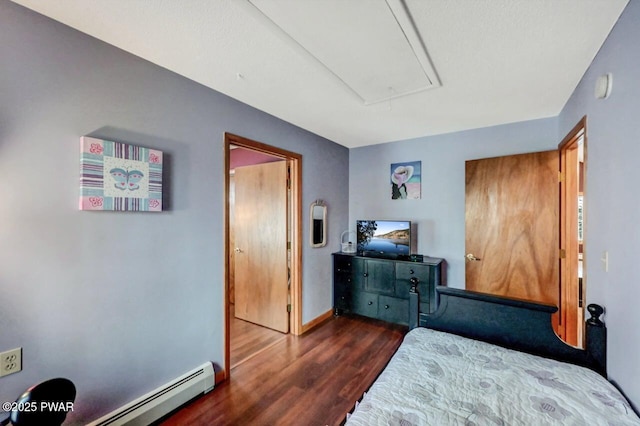 bedroom featuring attic access, baseboards, baseboard heating, and wood finished floors