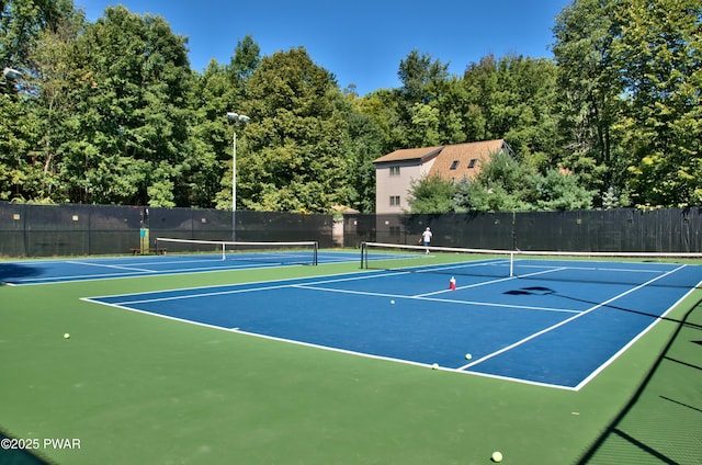 view of sport court featuring fence