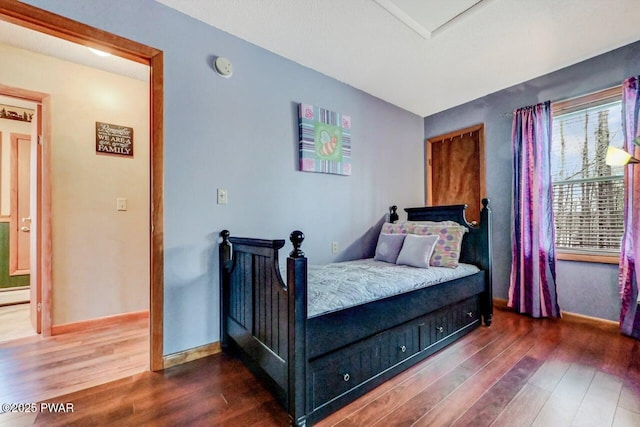 bedroom featuring dark wood-type flooring and baseboards