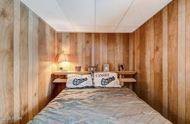 bedroom with wooden walls