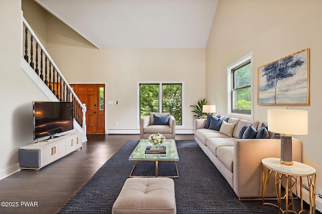 198 State Route 690, Springbrook Township, PA 18444 - living room featuring baseboard heating, dark wood finished floors, stairway, and high vaulted ceiling