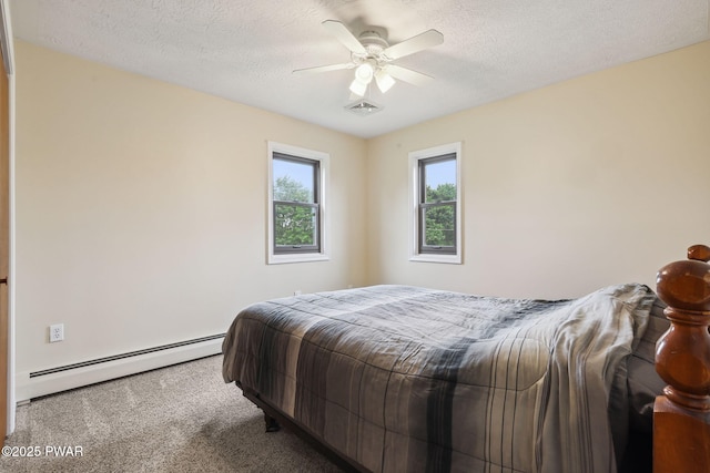 198 State Route 690, Springbrook Township, PA 18444 - carpeted bedroom with a baseboard heating unit, a ceiling fan, and a textured ceiling