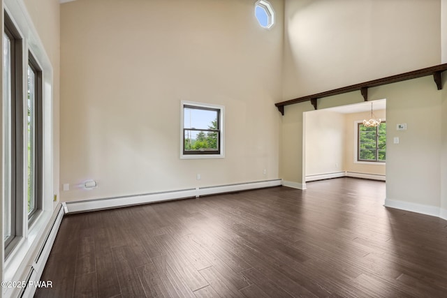 198 State Route 690, Springbrook Township, PA 18444 - unfurnished living room with a baseboard radiator, a baseboard heating unit, dark wood-style floors, a chandelier, and a high ceiling