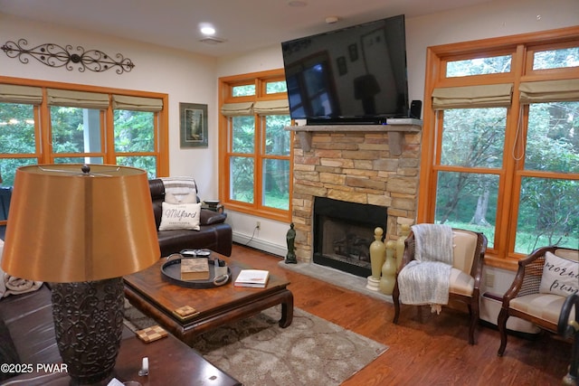 103 Valley Forge Rd, Milford, PA 18337 - living area featuring wood finished floors, a stone fireplace, plenty of natural light, a baseboard radiator, and recessed lighting