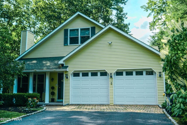 103 Valley Forge Rd, Milford, PA 18337 - view of front of property featuring driveway, an attached garage, a chimney, and roof with shingles