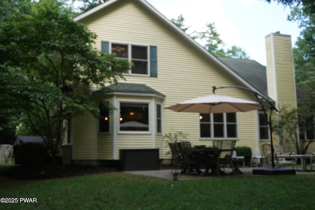 103 Valley Forge Rd, Milford, PA 18337 - back of property with a patio area, a chimney, and a lawn