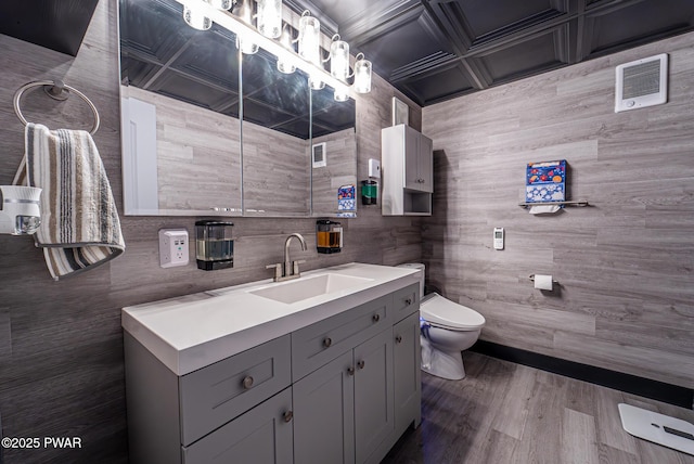 bathroom with vanity, toilet, and wood finished floors