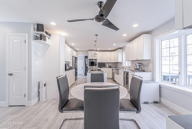 dining room with recessed lighting, ceiling fan, light wood-style flooring, and baseboards