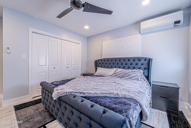 bedroom featuring recessed lighting, a closet, ceiling fan, wood finished floors, and a wall mounted air conditioner