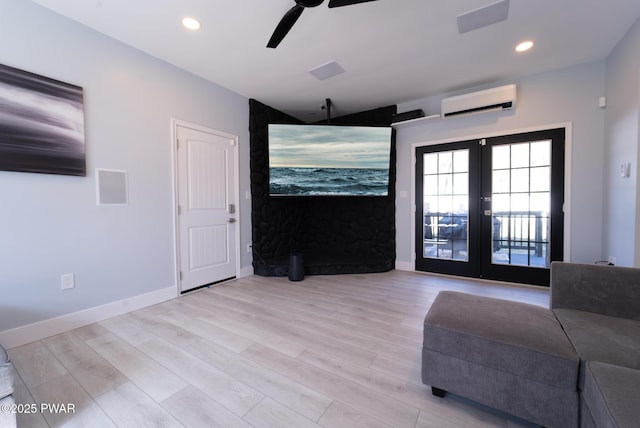 unfurnished living room with light wood-style flooring, recessed lighting, baseboards, an AC wall unit, and french doors