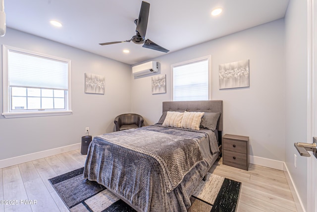 bedroom with light wood-style floors, recessed lighting, and a wall mounted air conditioner