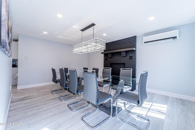 dining room featuring recessed lighting, an AC wall unit, baseboards, and wood finished floors