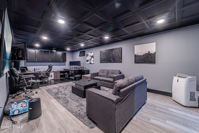 home theater featuring baseboards, recessed lighting, and light wood-style floors