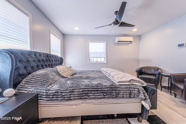 bedroom featuring recessed lighting, a ceiling fan, wood finished floors, and a wall mounted AC