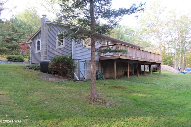 view of property exterior with a yard and a wooden deck