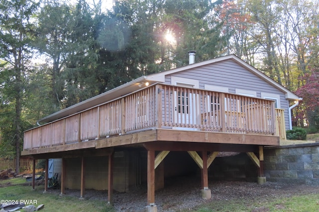 rear view of property featuring a wooden deck