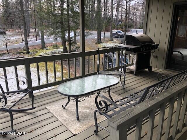 wooden deck featuring a grill