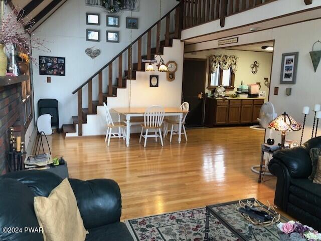 living room featuring a high ceiling and light hardwood / wood-style floors