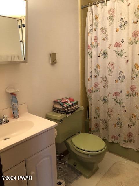 bathroom with tile patterned floors, vanity, and toilet