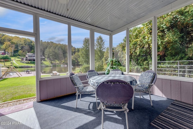 sunroom / solarium with plenty of natural light and a water view