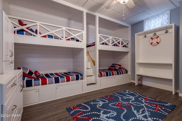 bedroom featuring a paneled ceiling, ceiling fan, and dark wood-type flooring