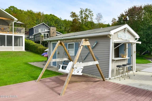 back of house with a yard and a wooden deck