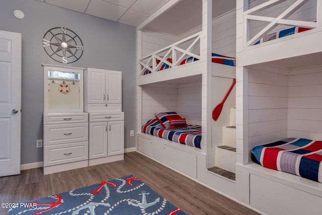 bedroom featuring dark hardwood / wood-style floors and a drop ceiling