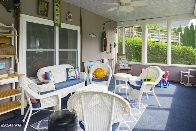 sunroom / solarium featuring ceiling fan