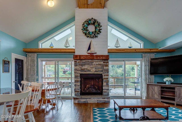 living room featuring a fireplace, wood-type flooring, a skylight, and a healthy amount of sunlight