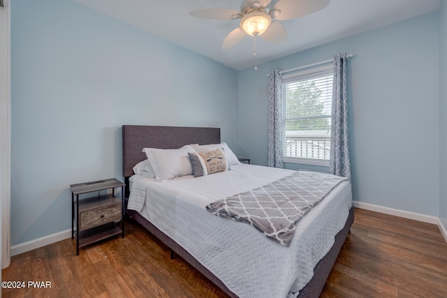 bedroom with dark hardwood / wood-style floors and ceiling fan