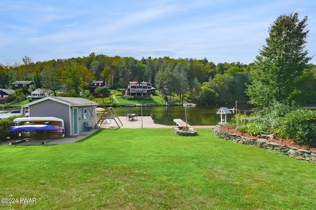 view of yard featuring a water view and a boat dock