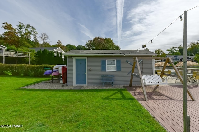 rear view of house with a deck and a lawn