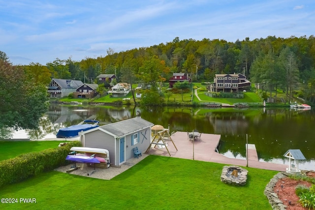 dock area with a water view and a yard