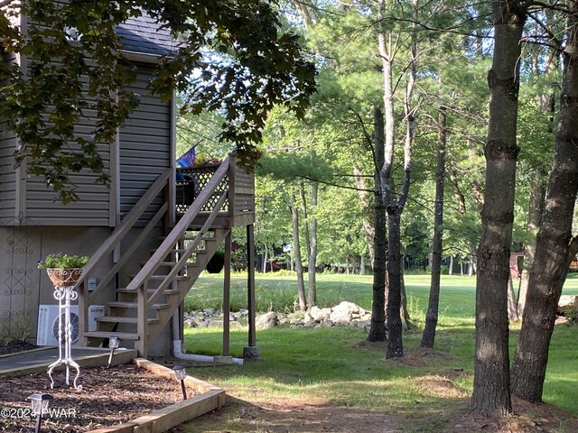 view of yard featuring ac unit and a deck