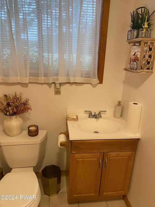 bathroom featuring tile patterned floors, vanity, and toilet