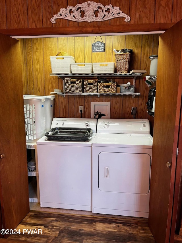 laundry room featuring dark hardwood / wood-style flooring and washing machine and clothes dryer