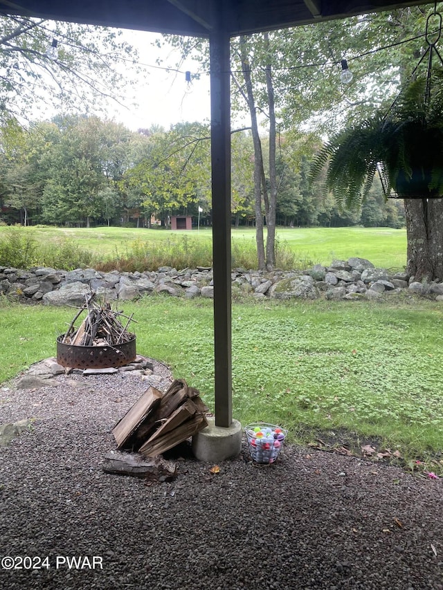 view of yard with a fire pit