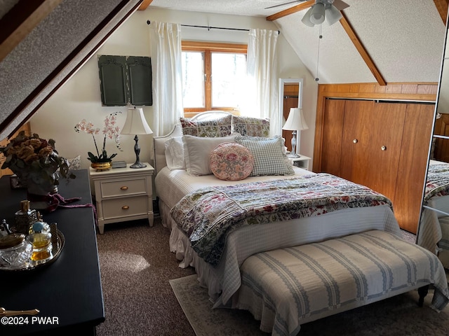 carpeted bedroom with a textured ceiling, ceiling fan, and lofted ceiling