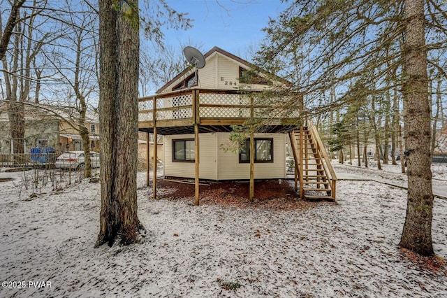 snow covered property featuring a deck