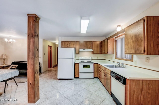 kitchen with a notable chandelier, white appliances, and sink