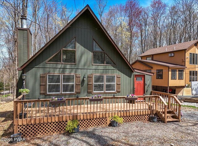 rustic home with a chimney and a deck