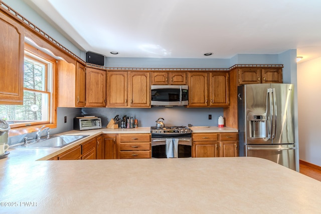 117 Circle Dr, Hawley, PA 18428 - kitchen featuring light countertops, stainless steel appliances, a sink, and a toaster