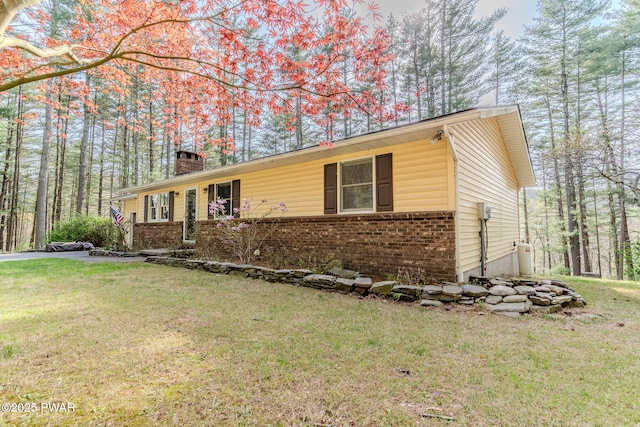 117 Circle Dr, Hawley, PA 18428 - ranch-style home featuring a chimney, a front yard, and brick siding