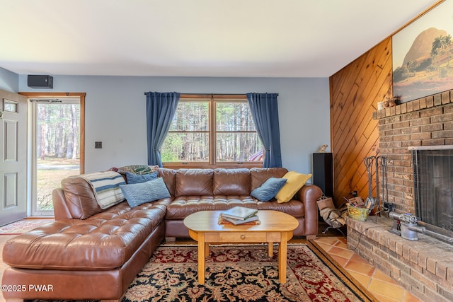 117 Circle Dr, Hawley, PA 18428 - living room featuring tile patterned floors, wood walls, a healthy amount of sunlight, and a fireplace
