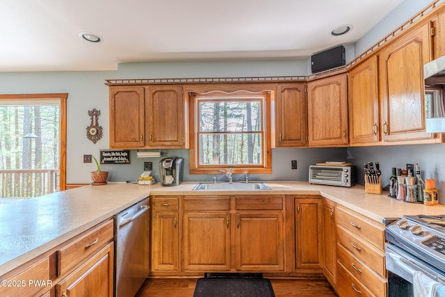 117 Circle Dr, Hawley, PA 18428 - kitchen featuring stainless steel dishwasher, a sink, a healthy amount of sunlight, and light countertops